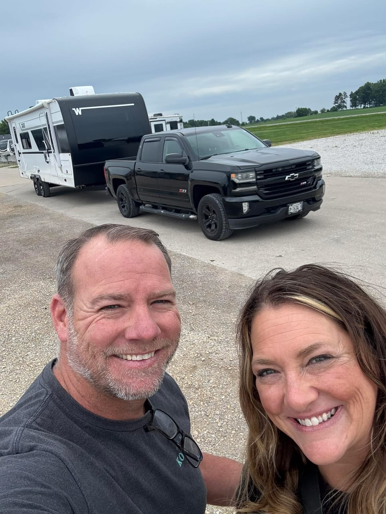 Jen and AJ with their camper and truck
